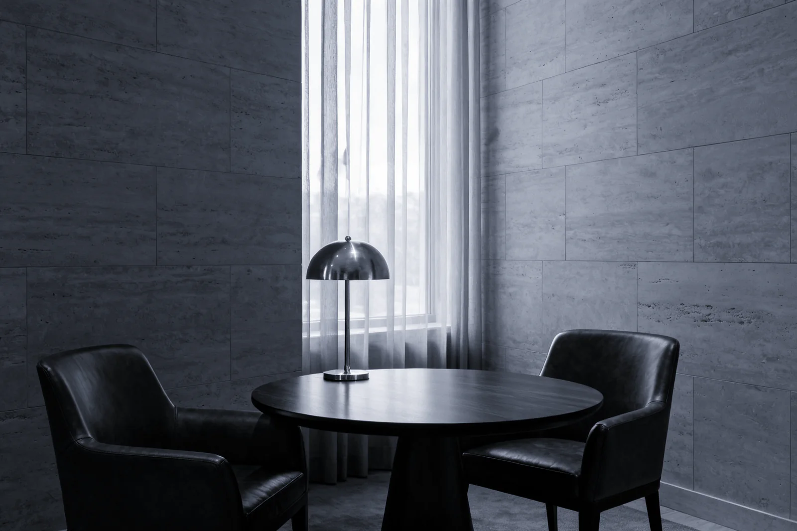 Three people silhouetted in a glass atrium